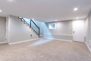 Light grey and spacious basement area with staircase upgrading your basement space