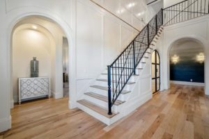 view of staircase from the foyer of home with multiple archways